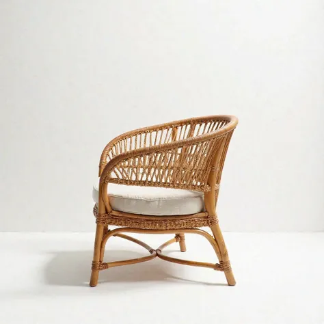 "A high-definition, professional studio photograph of an elegant rattan wicker armchair, centrally positioned against a seamless white background. The lighting is soft and diffused from both sides, enhancing the intricate woven texture and natural warm ton...