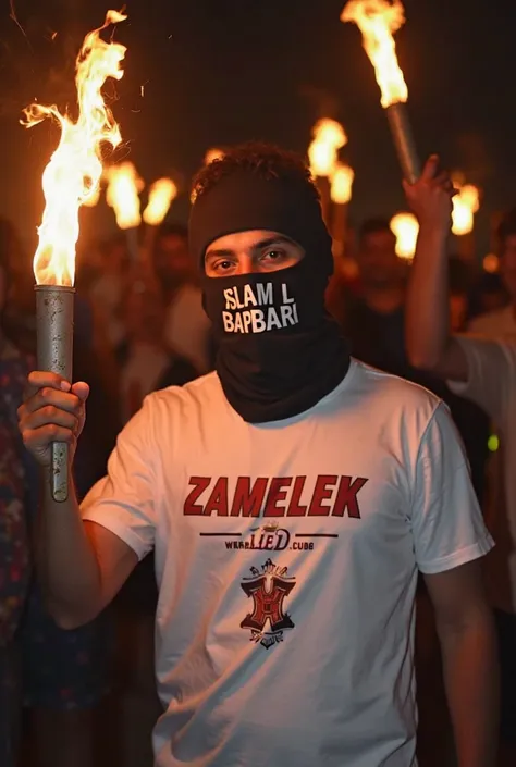 Pictures of a person holding torches in his hand, wearing a Zamalek Club T-shirt, the color of the T-shirt is white, his face is covered from the eyes, and he is wearing a mask on his face with the name Islam Al-Barbari clearly written on it