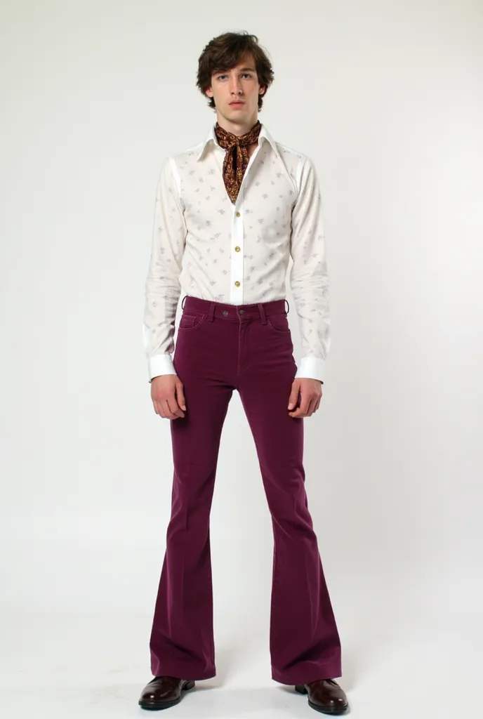 A young man standing against a white background wearing 1970’s  aubergine bell bottom pants and white tight shirt with wide lapels and small patterns also wearing a small scarf around his neck and 70’s men shoes