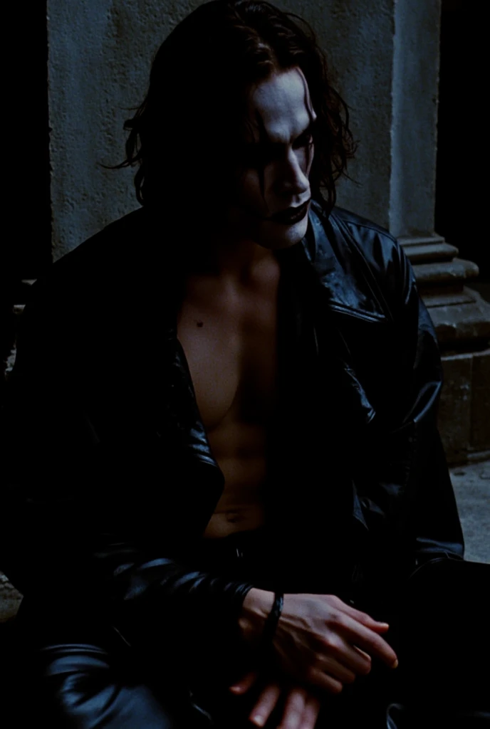 blurred image of a man sitting on the floor in a dark room, The character Eric Draven from the 1994 film The Crow, Brandon Lee, with his long black hair, black leather jacket, painted face, open jacket, showing his chest, Mysterious aesthetic , head down, ...