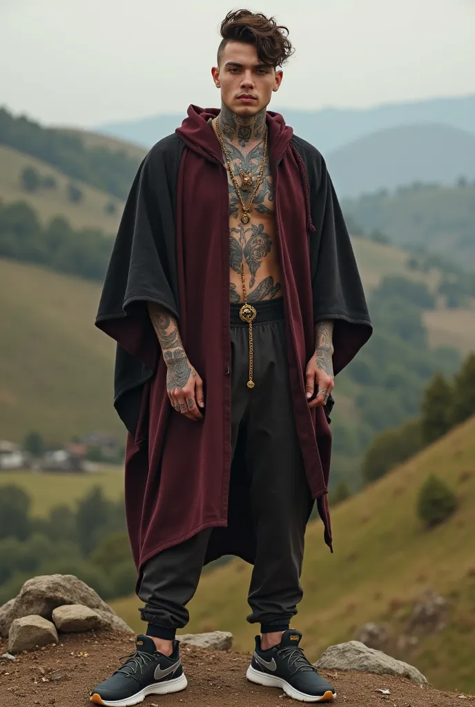 Young man with tattoo, with a burgundy and black poncho, That he has Nike sneakers, And that it is in the field with hills in the background