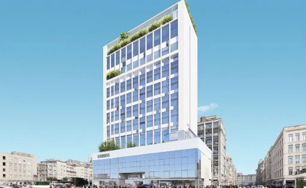 The center has 7 floors. 1st floor is used as shophouse . 2nd floor is commercial .3rd, 4th, 5th, 6,7th floors are offices for rent .rooftop with trees . street . background is townhouses and buildings. there are vehicles.crowded people . diverse architect...