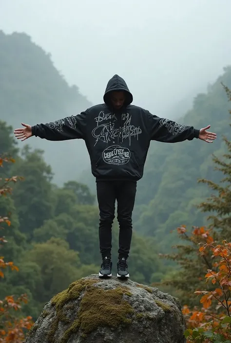 A young man wearing a loose black jacket with white graffiti on it, with black pants and dark. sports shoes, stands on a large rock covered with moss, in the middle of a dense forest covered with fog, giving a sense of adventure and departure..

The landsc...