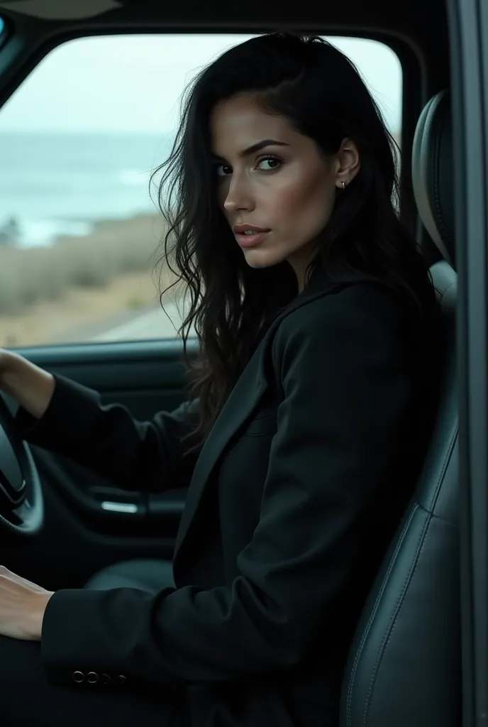 Turn of the coast white woman with long black hair slightly wavy expressive with bold and athletic style wearing a closed black coat dress sitting behind a wheel on a deserted road 