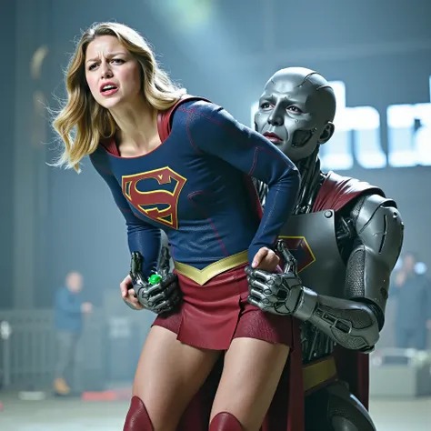 Melissa Benoist as Supergirl, (a very short skirt), both arms behind her back, she is locking by a green lighting locking devices, she is sexual assaulted from behind by Lex Luther the robot, embarrassment, ((painful face)), (Supergirl is crying in pain), ...