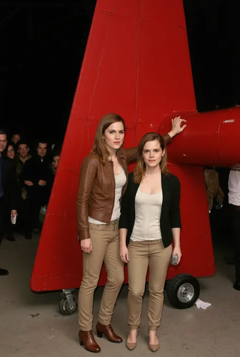 Emma Watson and Amy Adams photographed in front of a red plane　brown leather jacket　beige leather pants　leather boots　 night view　Put your hand on the plane