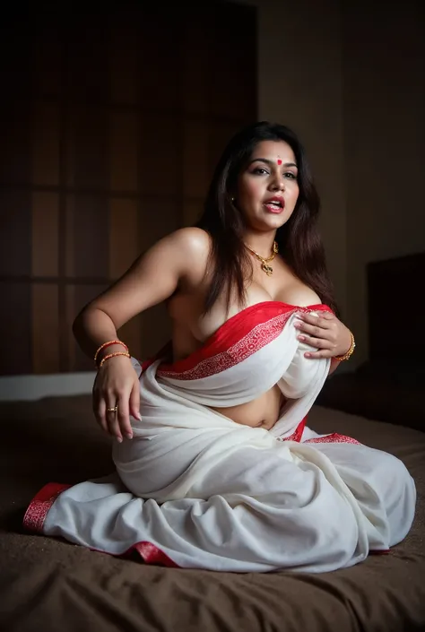 Indian mature woman lying on the corner of the bed.   She wore a white saree with a red border and a red blouse.   Open long black hair, nose ring, gold earring, red bangles, small red mark on forehead, thali on neck.   Sensual expression on face, moaning,...