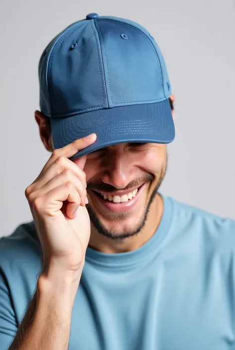 A man wearing a simple blue cap and a shirt, Lightly smiling and tilting your head slightly down, while holding the cap brim with one hand. The background is simple and light gray . Your expression is relaxed and cheerful, and his face is partially obscur...