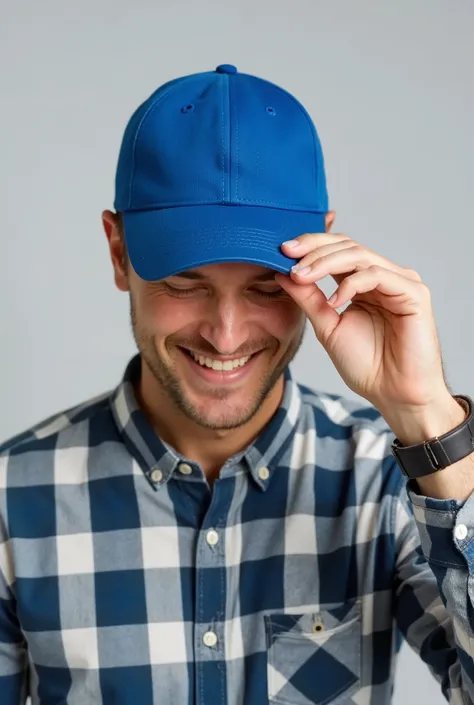 Close-up of a man wearing a simple blue cap and a plaid shirt, tilting the head slightly downward, while holding the cap brim with one hand. The background is simple and light gray . Your expression is relaxed and cheerful, and his face is partially obscu...