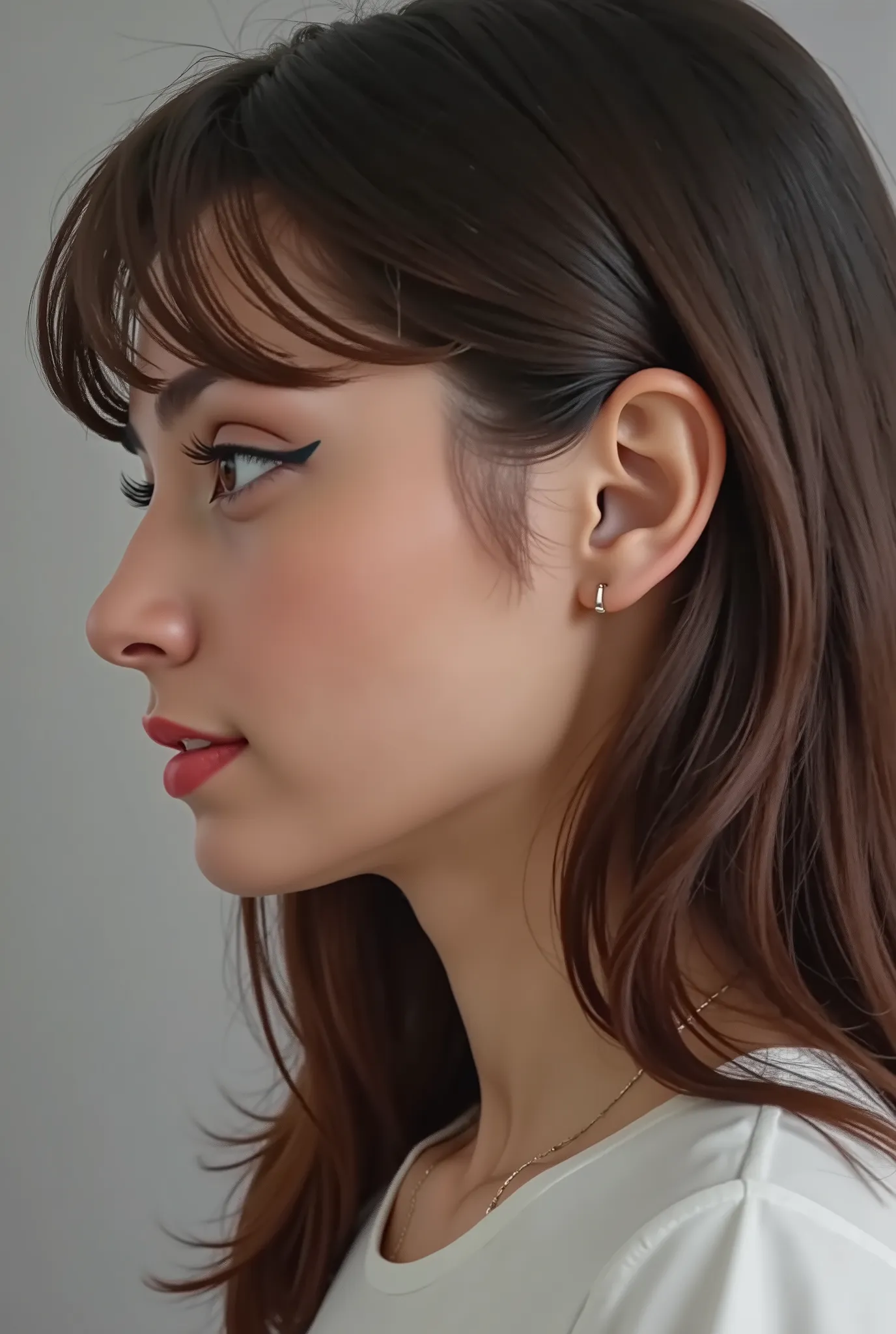 18 years, girl posing for the picture, profile shot, looking down, no hands, flat grey background, faceshot,
