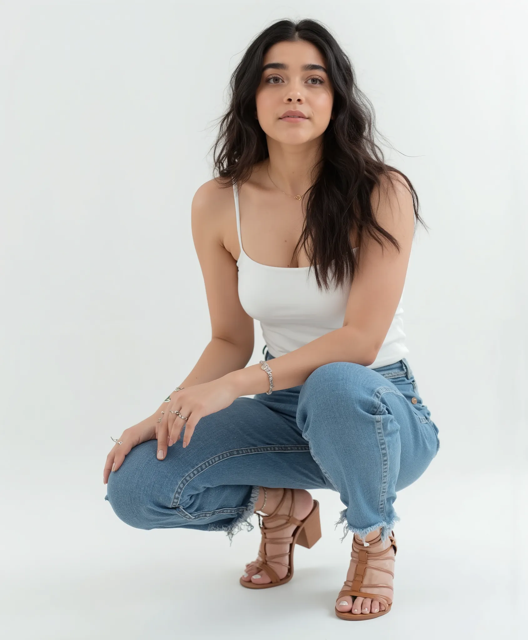 1M4N  , Portrait of a beautiful   woman squatting down in a minimalist studio, wearing a white tank top and blue high-waisted jeans, brown strappy block-heel sandals, clean background, soft lighting, sharp focus, casual pose, neutral expression, realistic ...