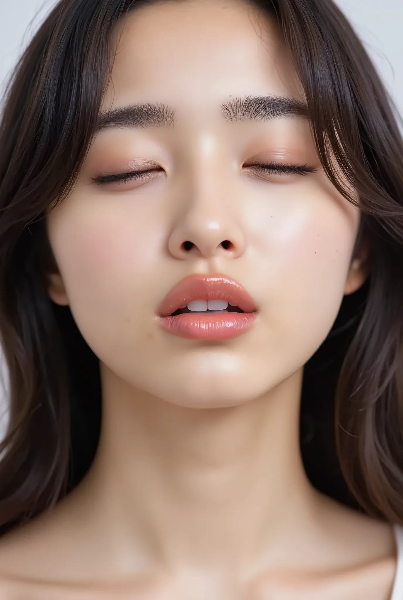 An ultra close-up of a stunning Japanese woman with glossy, puckered lips glowing with highlights, softly parted for a kiss. Her eyes half-closed in a dreamy, loving upward gaze, face tilted slightly downward, chin softly tucked in, making direct eye conta...
