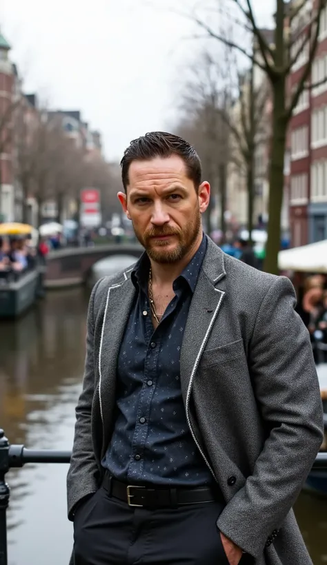Tom Hardy in gray blazer with white details on Amsterdam city background in high quality with people and a river