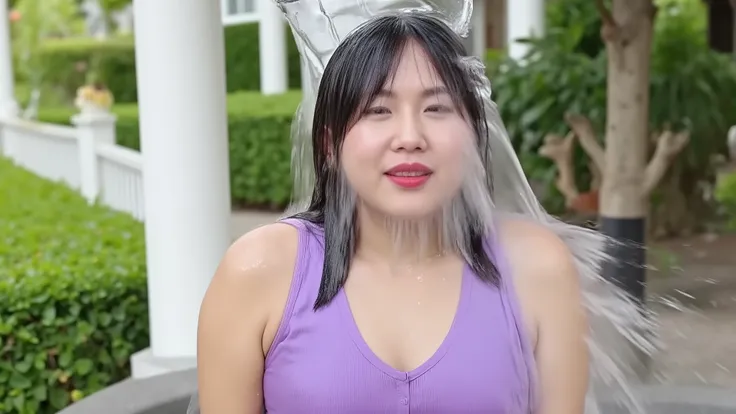 In the back garden of a house, Ikumi, wearing a purple satin dress, a delicate necklace, earrings and makeup including lipstick and sparkly eye shadow is absolutely soaked by a colossal cascade of water falling onto her head from off screen. The water land...