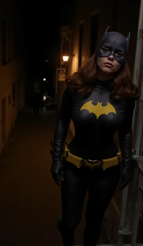 Nighttime. dark , full body shot of Christina Ricci with dark red hair viewed from directly above, dressed as batgirl wearing a full length charcoal gray rubber bodysuit molded to fit every curve of her body, with a yellow batgirl symbol on the chest, an...