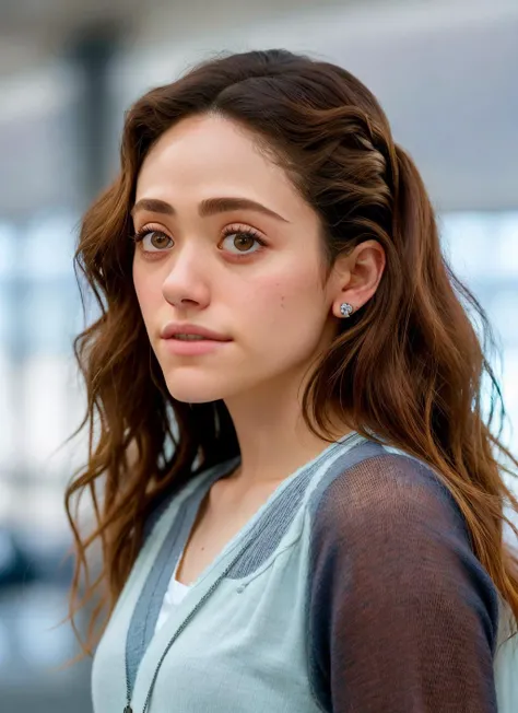 a close up of a woman with long hair and a blue shirt