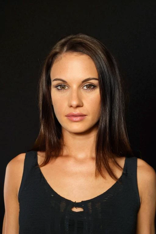 a woman with long hair and a black top posing for a picture