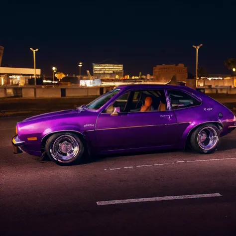 purple car parked in a parking lot at night with city lights in the background