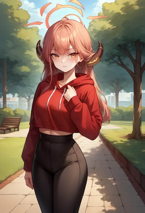 a woman in a red hoodie and black pants walking down a path