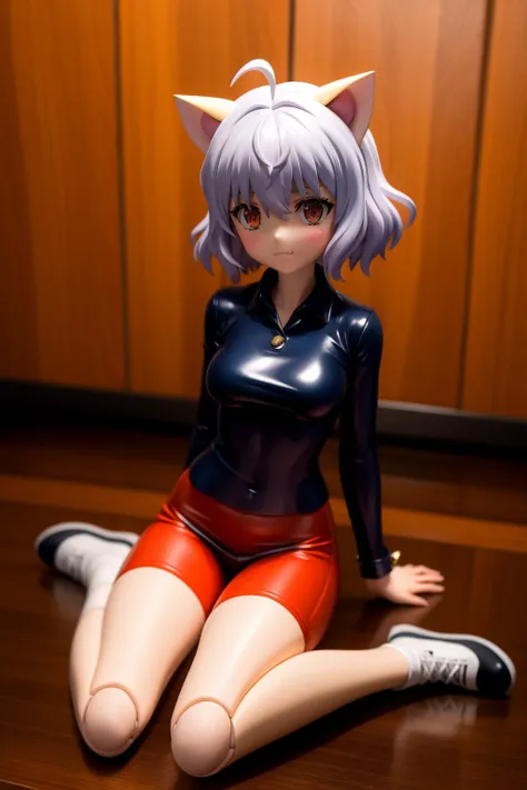 a close up of a toy figure of a cat woman sitting on a table