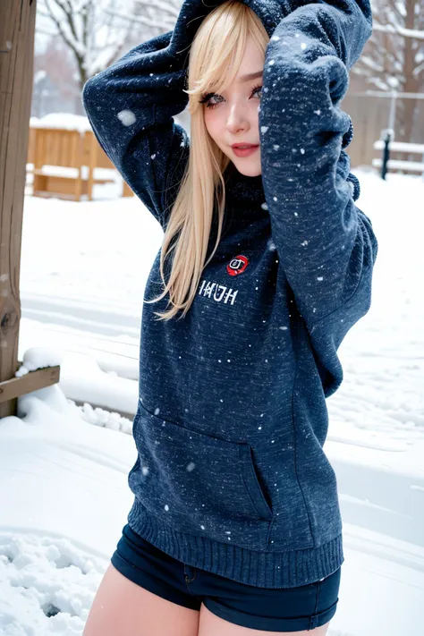 blond woman in a blue hoodie posing in the snow