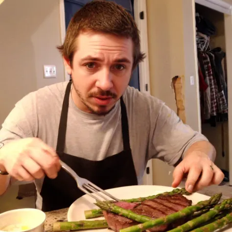 araffed man in apron cutting up a piece of steak with a fork