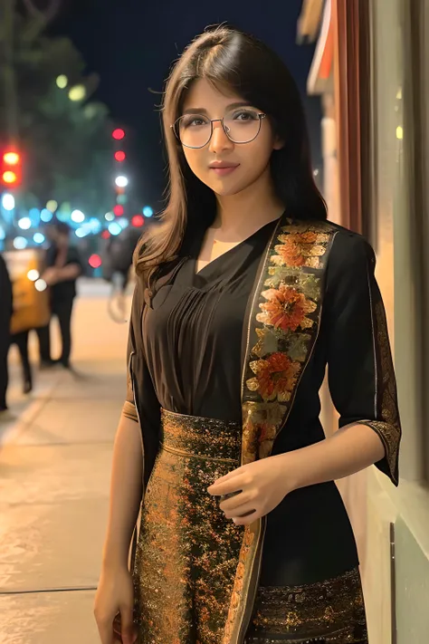 woman in a black dress and glasses standing on a sidewalk