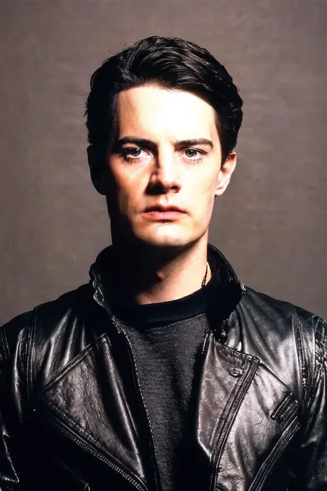 a man in a black leather jacket posing for a picture