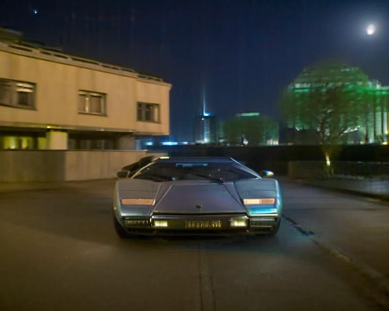 a close up of a car driving down a street at night