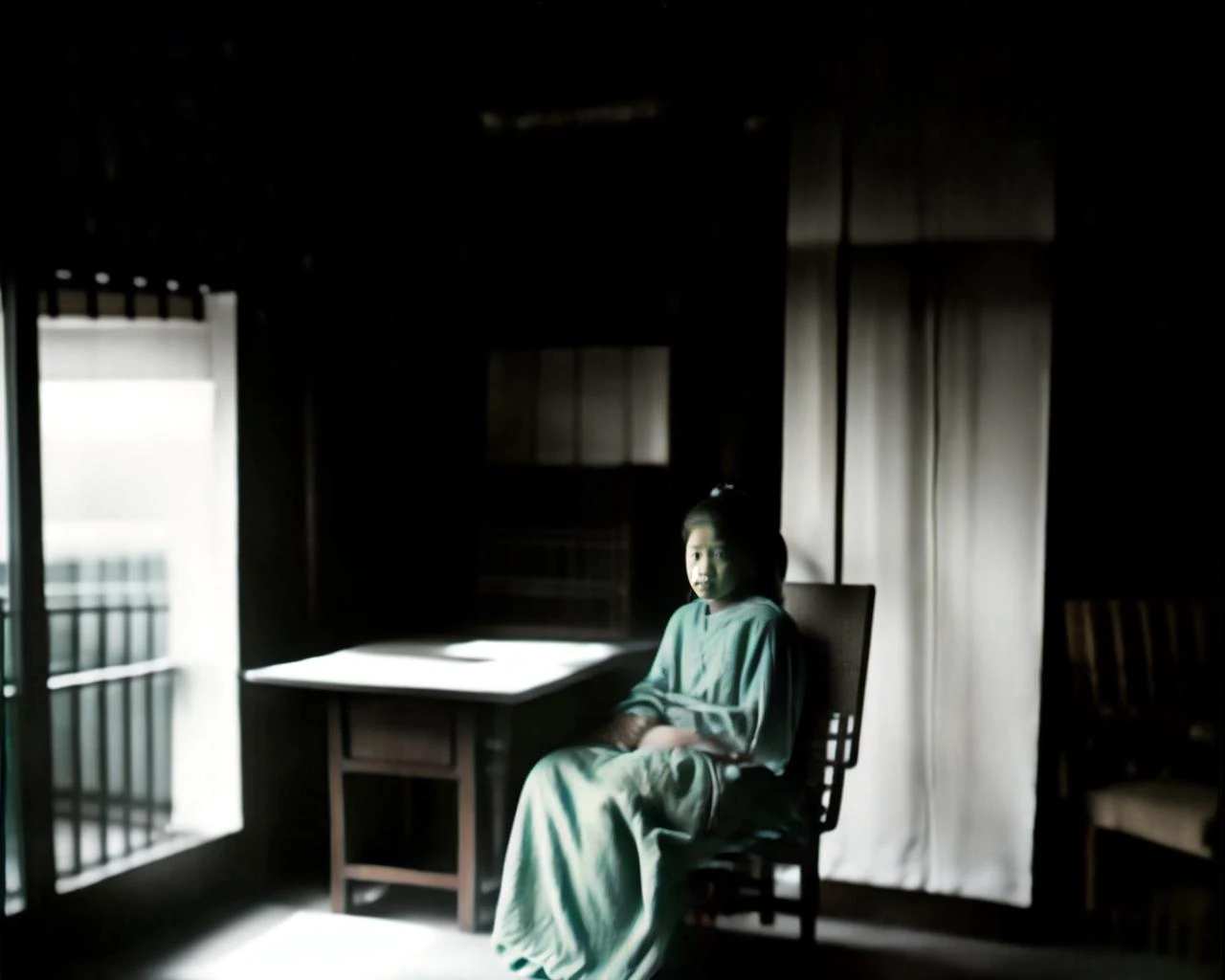 there is a woman sitting in a chair in a dark room