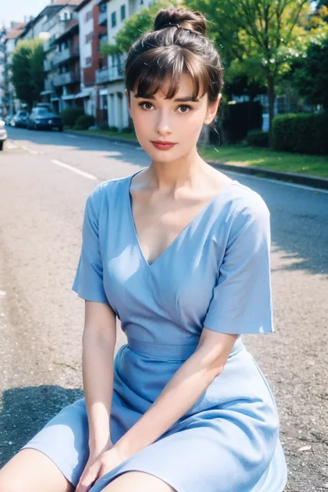 a woman sitting on the ground in a blue dress