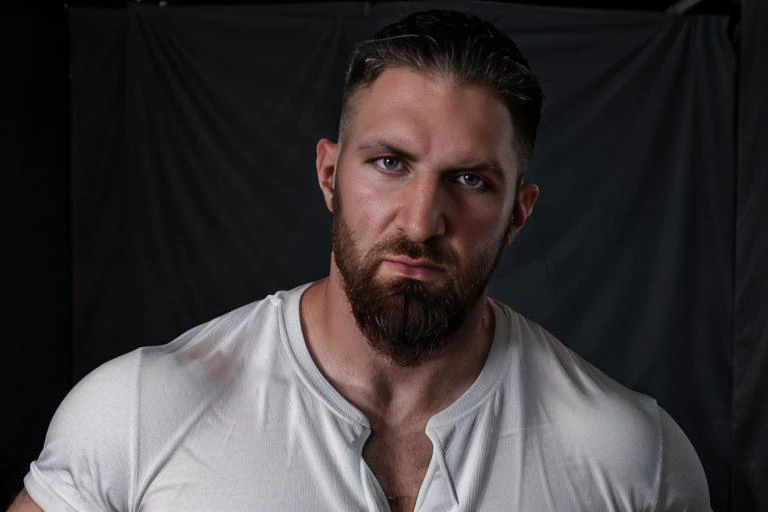 a close up of a man with a beard and a white shirt