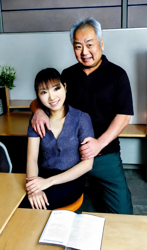 there is a man and woman sitting at a desk in an office