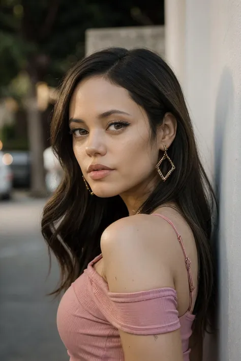 a woman with long hair leaning against a wall with a pink top