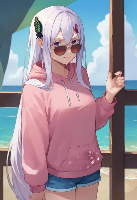 a woman in a pink hoodie and sunglasses standing on a beach