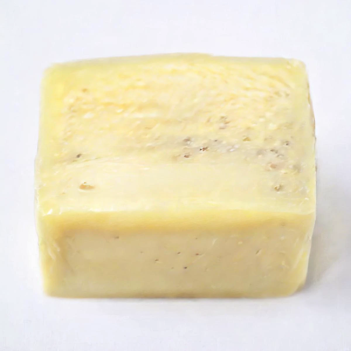 a photo of a square-shaped swiss cheese on a white plate, chunks, <lora:chunks3:1>, high resolution, beautiful, highest quality, masterpiece, highly detailed