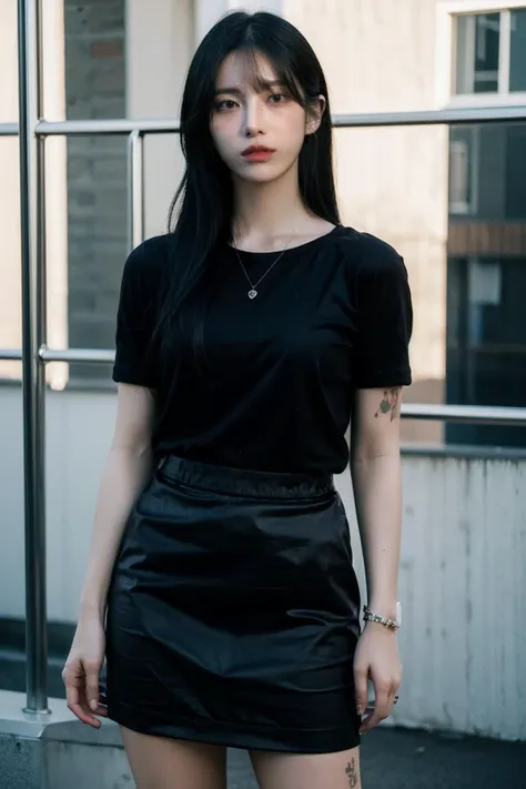 a woman in a black top and black skirt posing for a picture