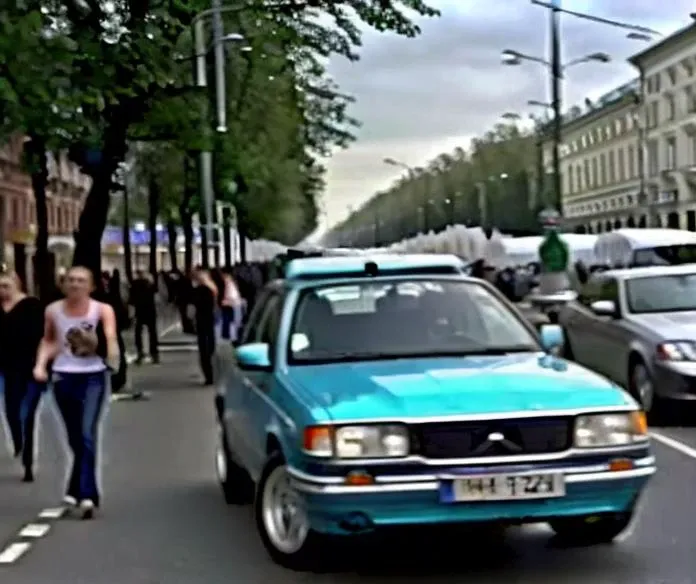 cars and pedestrians on a busy city street with tall buildings