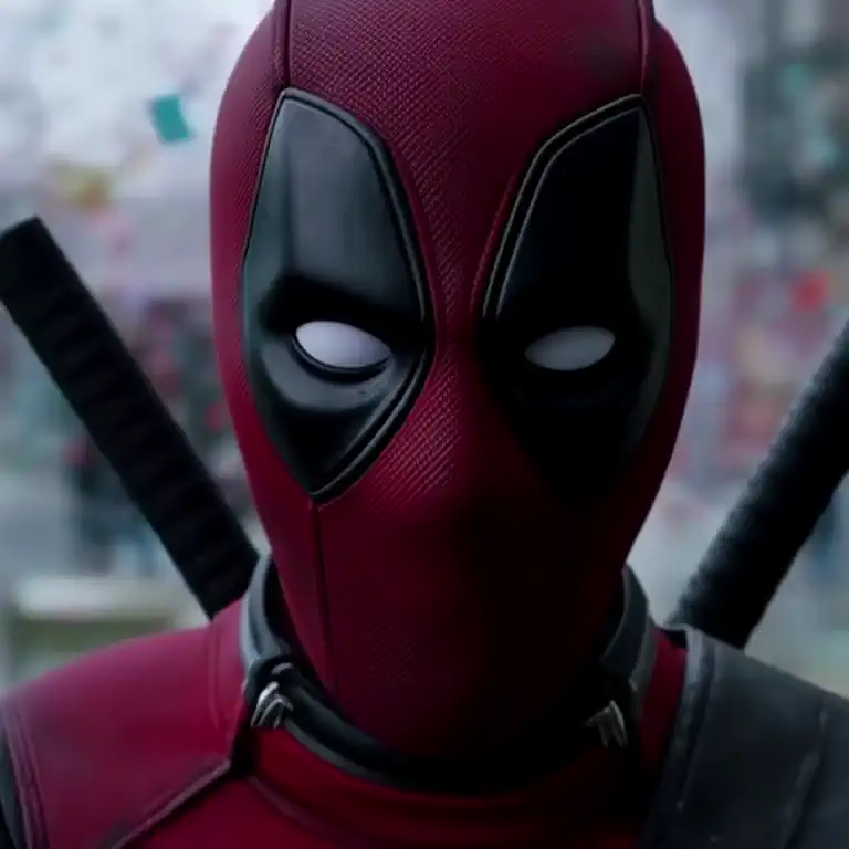 d011Ye33ect The video is a playful close-up of Deadpool’s irreverent grin peeking out from his mask, his eyes filled with sass. The camera zooms in on his cheeky expression before zooming out to reveal him breaking the fourth wall with a flurry of witty one-liners and chimichanga confetti. This is a dolly in, zoom out effect.