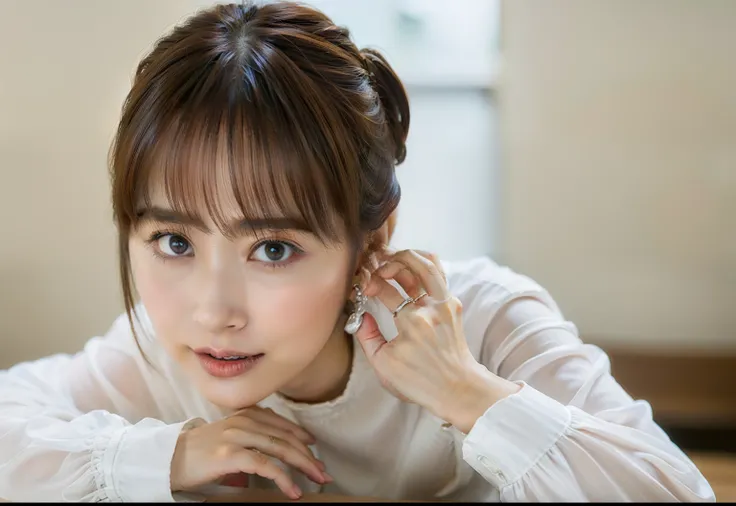 There is a woman lying on a table in a silver long-sleeved shirt and posing,