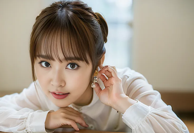 There is a woman lying on a table in a silver long-sleeved shirt and posing,