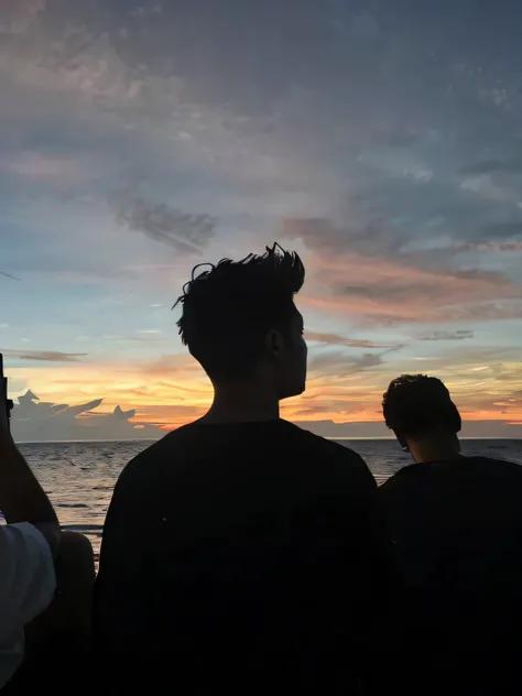 People are watching the sunset on the beach with their phones, watching the sunset, looking out at a sunset, looking out at a sunset, With sunset, watching the sunset, late sunset, gazing off into the horizon, Looking into the distance, looking at the dist...