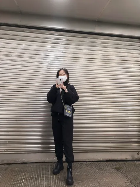 woman in black jacket taking a picture of herself with a cell phone, stood outside a corner shop, wearing japanese techwear, wearing all black mempo mask and sunglasses, photograph taken in 2 0 2 3, masked person in corner, in front of ramen shop, photogra...