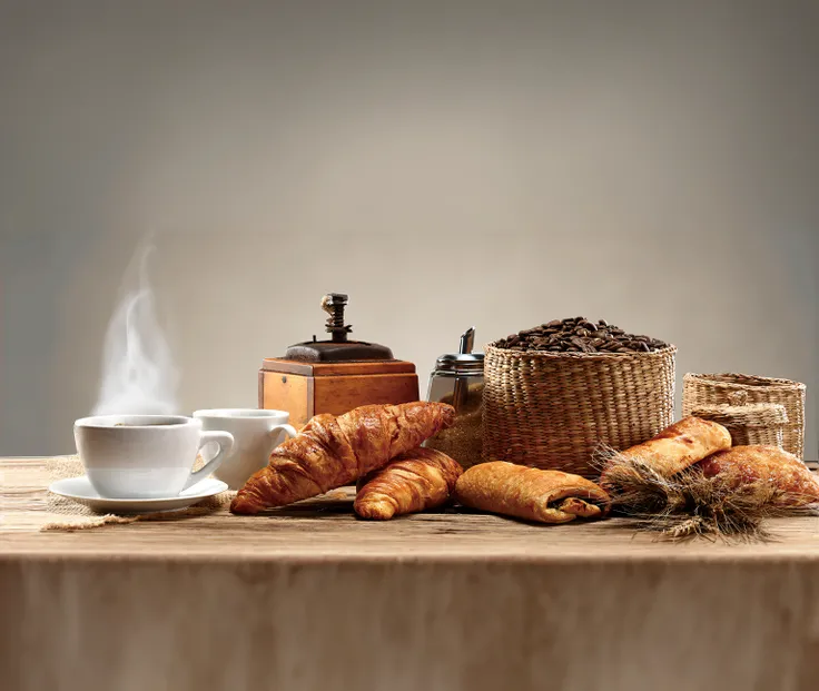 There was a cup of coffee and croissants on the table, high quality food photography, celebration of coffee products, patisserie, Rustic, highly detailed composition, advertising photograph, breakfast, author：Bernard DeAndrea, photorender, author：David Gar...