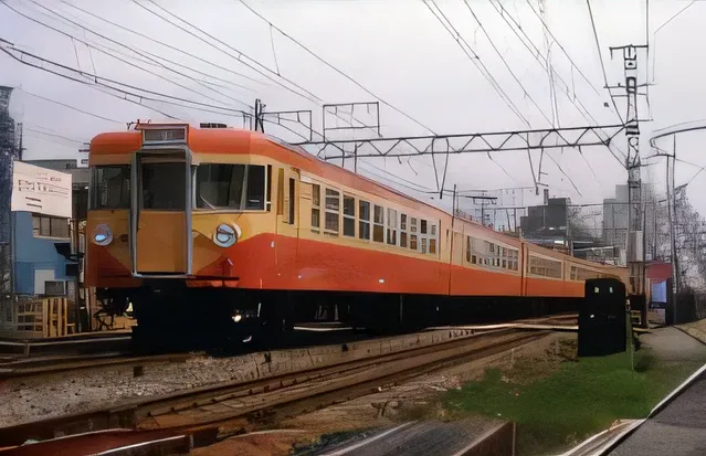 Arafly colored train on city tracks, orange line, Red and yellow scheme, set in 1992 japan, stage:1982 Tokyo, Single line, kantoku, Yellow red scheme, けもの, Scarlet and yellow scheme, sōsaku hanga, sosaku hanga