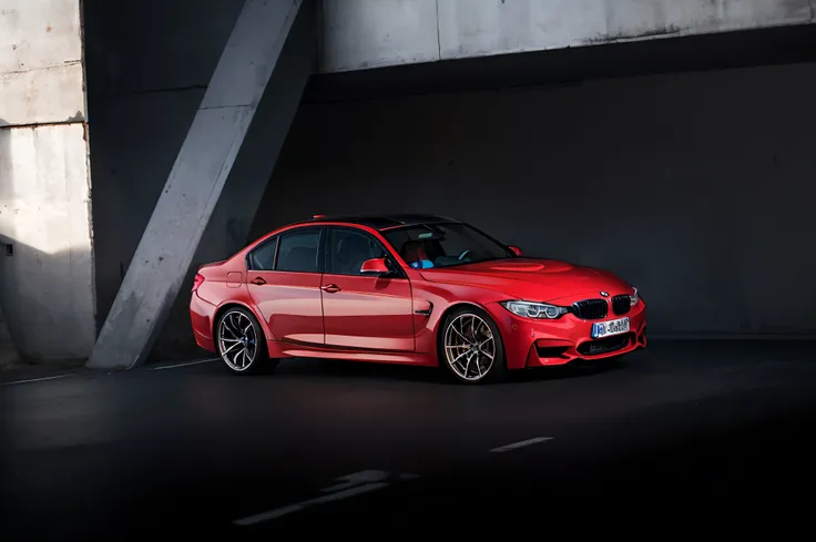 Red BMW M3 four-door car parked in garage，Shoot diagonally from an angle upwards，Small aperture，depth of fields，hyper HD，real photograph，Delicate light and shadow，real textures，Rich in detail，advertisement photography，commerciaphotography，Car promo，8K