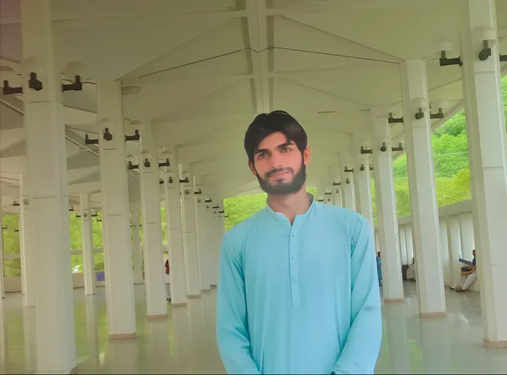 there is a man standing in a building with a blue outfit, he is in a mosque, handsome man, at college, wearing a kurta, kyza saleem, very very low quality picture, very clear picture, khyzyl saleem, taken with the best dlsr camera, full body photogenic sho...