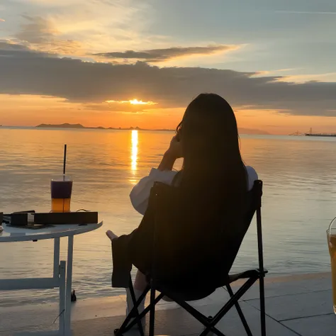 Arapei sat in a chair at the table and drank drinks and drinks, With sunset, with a sunset, girl watching sunset, watching the sunset, at a beautiful sunset, looking out at a sunset, sentado em frente a um lago, at the sunset, watching the sunset. anime bi...