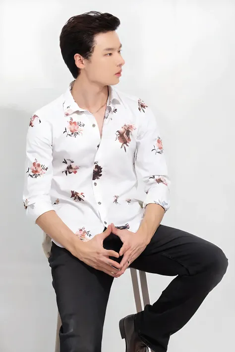 a man sitting on a stool wearing a white shirt with a floral print, wearing a white button up shirt, wearing in shirt, wearing white shirt, wearing a white shirt, with a white background, floral clothes, white trendy clothes, wearing a shirt, modern casual...