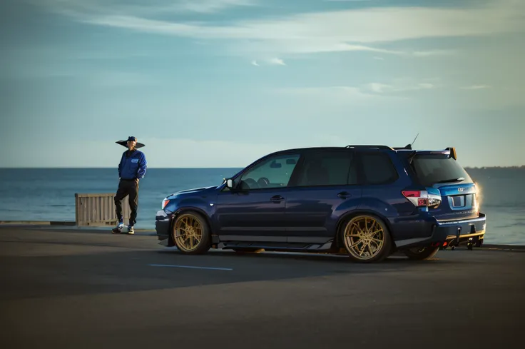 Arafard Blue Subaru Forester on the pier，A man stands in the background, epic stance, shot at golden hour, Wide body, vehicle photography, perfectly poised, Subaru Forester, Silvertone, tuning, automotive photography, taken at golden hour, automotive photo...